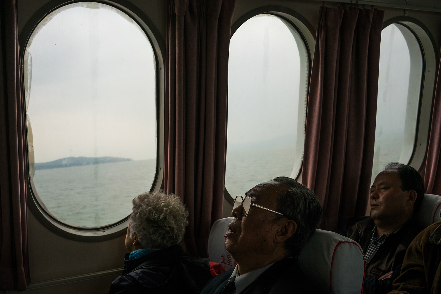 On the 30-minute ferry ride from Xiamen’s Wutong ferry terminal to Kinmen, an elderly mainland Chinese tourist takes a nap while his female companion looks out the window as the boat crosses from Chinese to Taiwanese territory in the Taiwan Strait. The ferries were launched as part of the ‘Mini-Three-Links’ between China and Taiwan in 2001. More than 1.5 million passengers traveled by ferry in 2014 between Fujian, in China, and Kinmen. Since 2015, Chinese tourists traveling to Kinmen can easily get visas on arrival, a move to encourage mainland Chinese tourism.